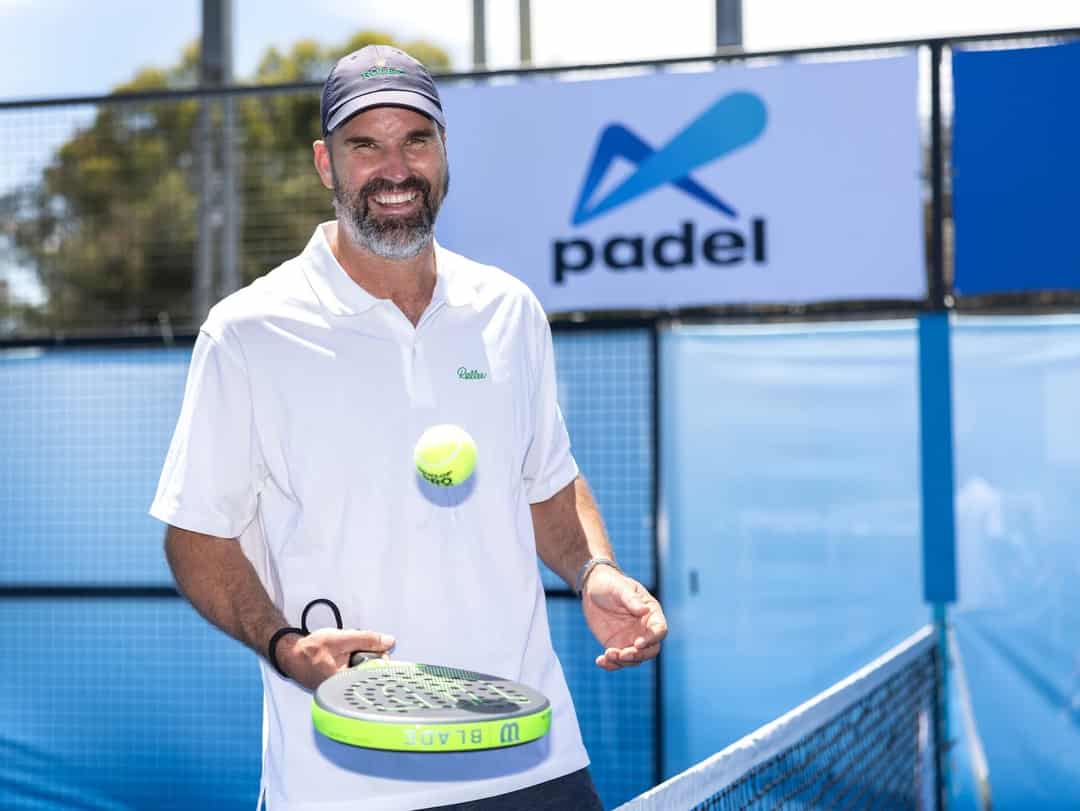 Pat Rafter met padelracket en bal op een padelbaan in Australie