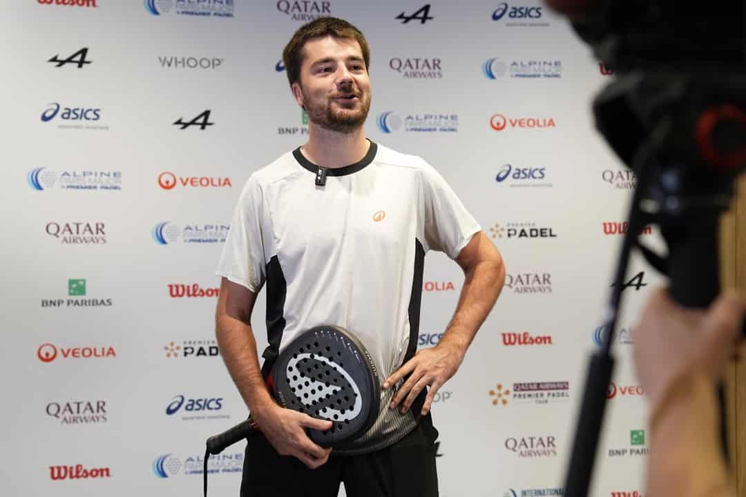 Speler met racket staat de media te woord voor de sponsorwand van het Paris Major op Roland-Garros