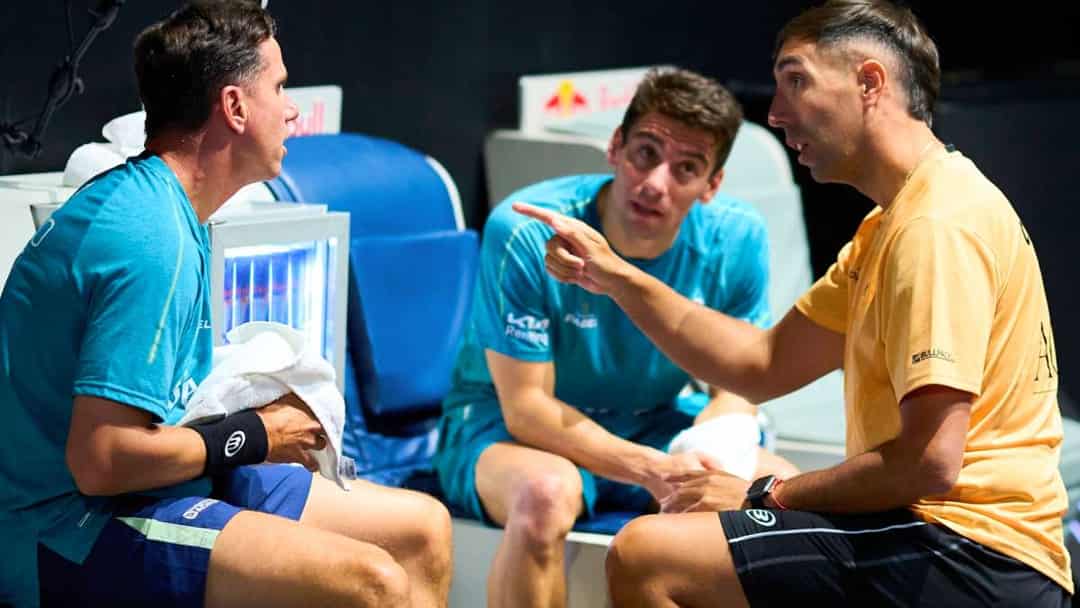 Padelspelers overleggen op de bank tijdens een pauze in een wedstrijd op het Premier Padel-circuit